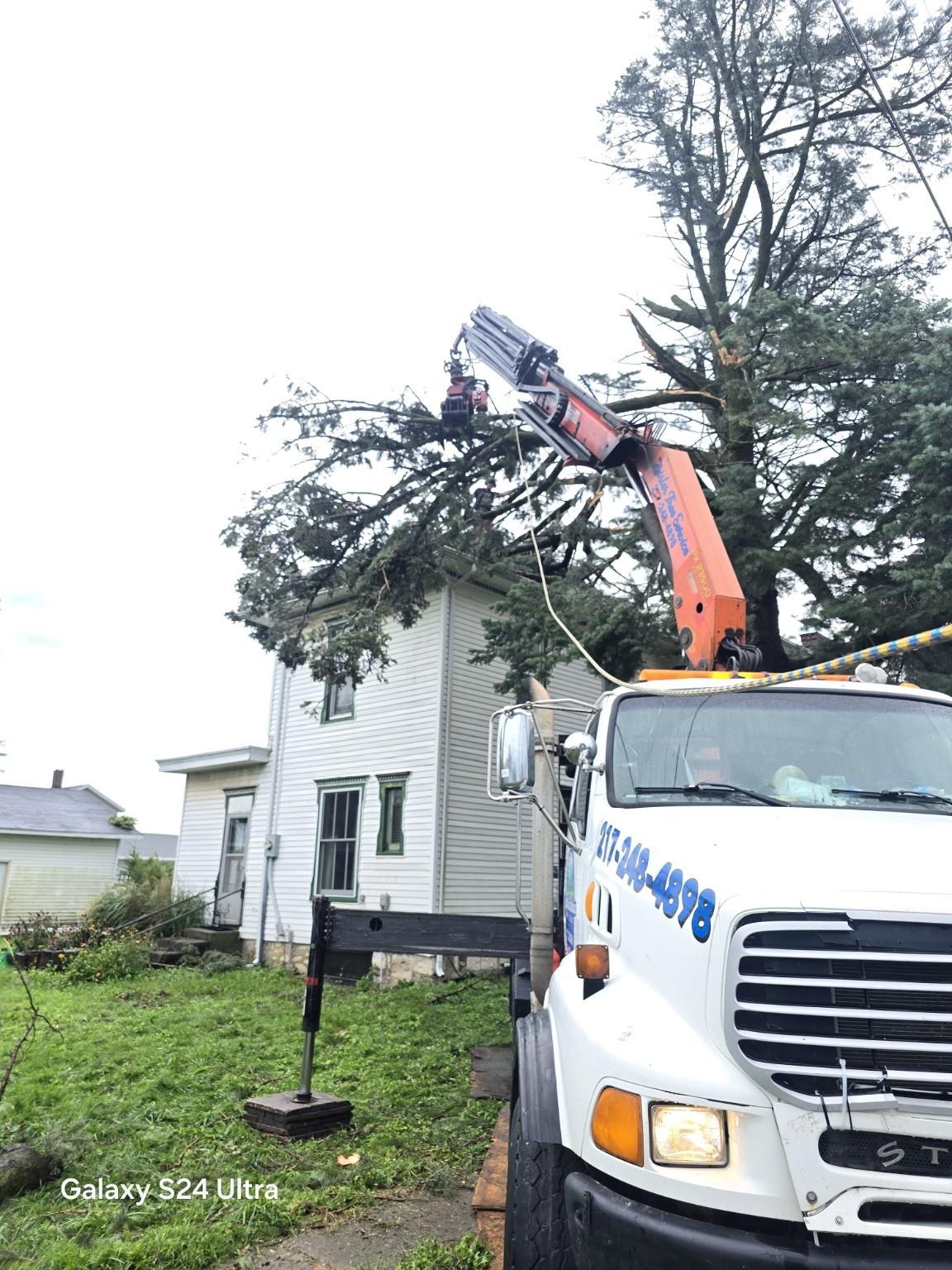 Zeisler Tree Service truck and crane at a residential removal